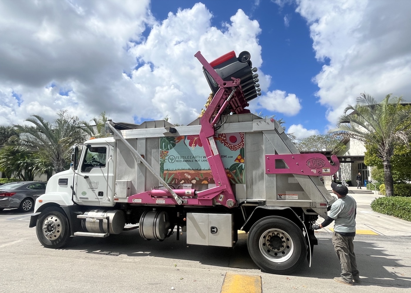 Fertile Earth compost pickup truck emptying an organics bin during commercial collection